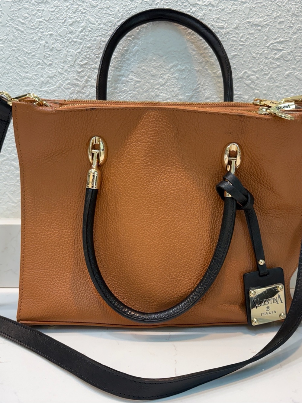 Valentina Tan & Black Pebbled Leather Satchel with crossbody strap.